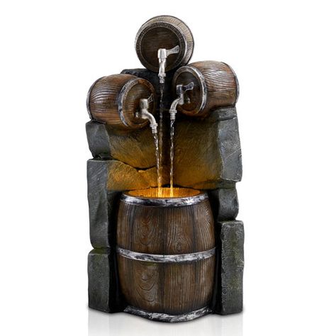 This fountain is perfect for the wine connoisseur in your life! The rustic charm of the fountain is highlighted by the three wine bottles pouring water into the wine barrel below. Crafted from poly resin material, the fountain is perfect for your patio, porch, or deck. Relax with your favorite wine on your deck while the fountain's wine bottles gently pour water into the water barrel. The fountain can be enjoyed at night with the lovely LED light that gently highlights the wine bottles perched o Rustic Taps, Whiskey Barrel Fountain, Rustic Faucets, Barrel Fountain, Outdoor Waterfall Fountain, Patio Fountain, Water Wall Fountain, Outdoor Waterfalls, Modern Fountain