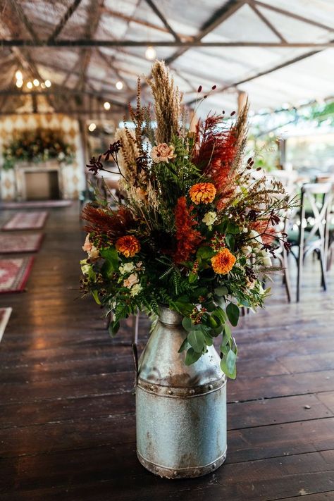 Vintage milk churn with orange, red and beige dried grass and flowers Orange And Red Wedding, Sage Green Wedding Flowers, Dried Wedding Flowers, Rustic Flower Arrangements, Grass And Flowers, Wedding Decor Rustic, Rusting Wedding, Olive Wedding, Milk Churn