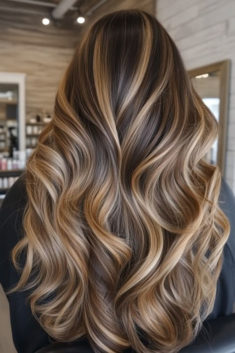 Long, wavy hair with blonde and brown highlights in a salon setting. Fall Caramel Balayage Brunette, Different Color Balayage Hair, Cream Highlights Brown Hair, Long Hair With Layers Balayage, Different Hair Highlights, Hair Inspiration Highlights, Honey Lowlights, Highlights Subtle, Brown Balayage To Blonde