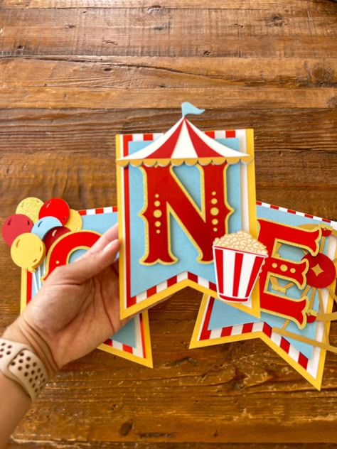 "Circus High Chair Banner Celebrate your little one with this beautifully handcrafted circus highchair banner.  This highchair banner is handcrafted with premium cardstock. It measures at 18 in wide.  My estimated shipping time may not be accurate. Whatever date is listed under \"Personalization\" is the earliest date I'm taking orders for. It is very important that I have your date! If no date is left (or it is farther out) your order will ship closer to my max shipping time, in which case the Diy Circus Party Decorations, Circus Birthday Banner, Diy Circus Decorations, Carnival Decorations Ideas, Circus Theme Party Decorations, Circus Theme Decorations, Circus Party Decor, Carnival Banner, Circus Banner