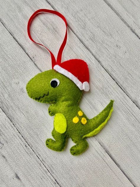 a colorful dinosaur ornament of felt with a cone hat is a fun and bold idea for winter, your kids will be very happy Unusual Christmas Decorations, Dinosaur Christmas Tree, Dinosaur Christmas Ornament, Yellow Dinosaur, Fabric Christmas Decorations, Felt Ornaments Diy, Felt Christmas Tree Decorations, Colorful Dinosaur, Dinosaur Ornament