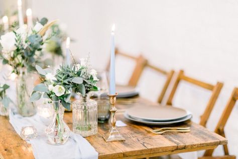 Reclaimed wood trestle table with an elegant baby blue silk table runner, bud vases and tapered candles. Taper Candles And Bud Vases, Candles And Bud Vases, Bud Vase Centerpiece, Blue Taper Candles, Becoming An Event Planner, Family Style Table, Baby Blue Weddings, Elegant Winter Wedding, Blue Table Runner