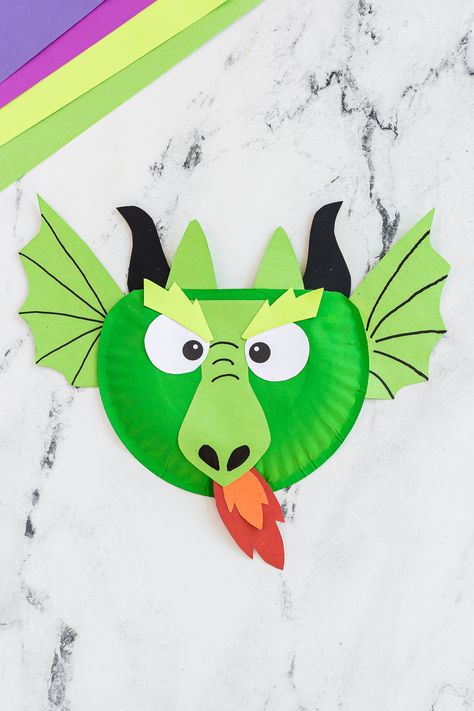 A fierce yet simple paper plate dragon craft activity that kids of all ages are sure to love any time of year. Dragon Arts And Crafts For Kids, Paper Plate Dragon, Dragon Craft, Dragon Plate, Dragons Love Tacos, Dragon Hats, Dragon Crafts, Teaching Lessons, Dragon Puppet