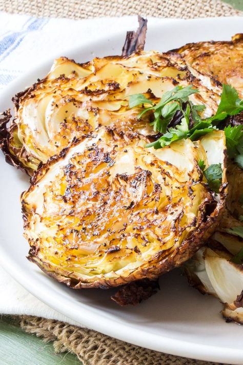 Easy roasted cabbage basted with garlic paste and either fennel or caraway seeds for a super-easy side dish. They take 10 - 15 minutes of prep, and only 4 ingredients (+ salt and pepper). #RoastedCabbage #HealthyRecipes #LowCarb #CleanEating #RoastedCabbageWedges #RoastedVegetables #VegetarianRecipes #VeganRecipes #Recipe #Recipes #CabbageSteaks #TheWimpyVegetarian Roasted Cabbage Steaks, Cabbage Steaks, Roasted Cabbage, Resep Diet, Caraway Seeds, Think Food, Veggie Side Dishes, Cabbage Recipes, Garlic Paste