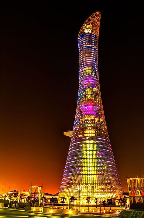 Aspire Tower, also known as The Torch Doha, is a 300-metre-tall (980 ft) skyscraper hotel located in the Aspire Zone complex in Doha, Qatar. Designed by architect Hadi Simaan and AREP and engineer Ove Arup and Partners. The tower is currently the tallest structure and building in Doha and Qatar, but it will be surpassed by the Dubai Towers Doha and the Barwa Tower, when either project is completed. The tower has also been known as Khalifa Sports Tower or Doha Olympic Tower. Qatar House, City Life Photography, Facade Lighting, Qatar Doha, Landmark Buildings, The Torch, Interesting Buildings, Doha Qatar, Amazing Buildings