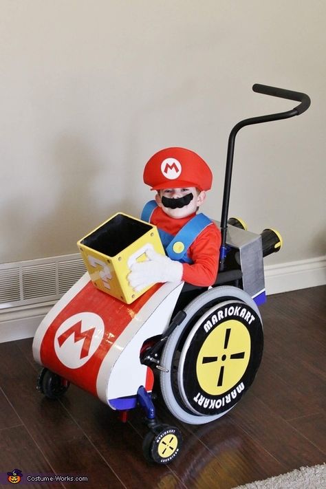 This is my 4 year old son who loves Mario (really ... who doesn’t!). I asked him what he’d like to look like and he said “Mario driving” ... so that’s where “Mario Kart” came into play! I made everything on his wheelchair by hand.... Mario Kart Wheelchair Costume, Mario Stroller Costume, Mario Kart Costumes, Wheelchair Costumes, 2017 Halloween Costumes, Eve Costume, Mario Costume, Video Game Costumes, Homemade Costume