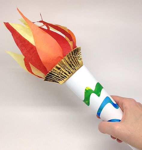 Hand holding a finished paper torch. Diy Torch, Torch Craft, Olympic Torch Craft, Vbs Olympics, Preschool Olympics, Olympic Theme Party, Olympic Games For Kids, Olympic Idea, Kids Olympics