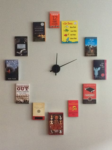 My book clock! Each book features a number in the title to represent the numbers on the clock. Bookstore Decor Ideas, Hanging Books, Book Wall Decor, School Library Displays, Book Clock, Book Furniture, Bookstore Cafe, Book Wall Art, Book Cafe