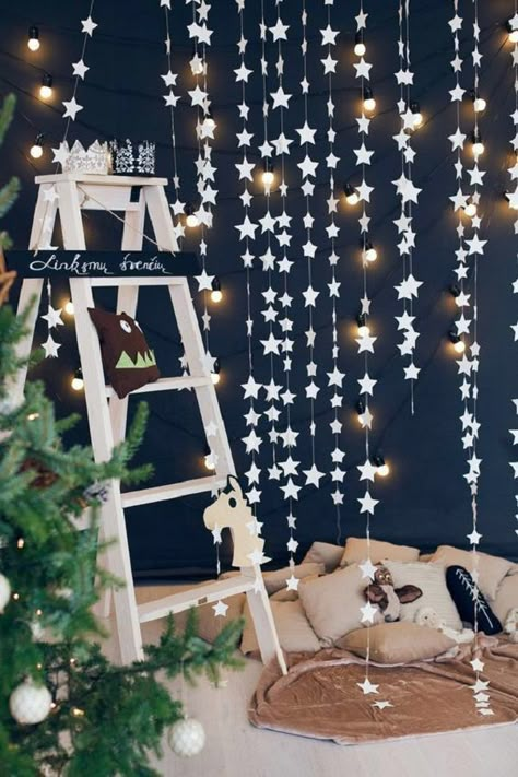 Starry Night - This DIY project works best if you have a dark blue wall as your background. Cut out a lot of stars from paper and use strings to make several ropes with stars attached to them. Hang lights from some of the stars and have yourself a holy night. Diy Holiday Decorations, Starry Night Wedding, Dark Blue Walls, A Ladder, Christmas Backdrops, Christmas Photography, Christmas Photoshoot, Diy Holiday Decor, Christmas Minis