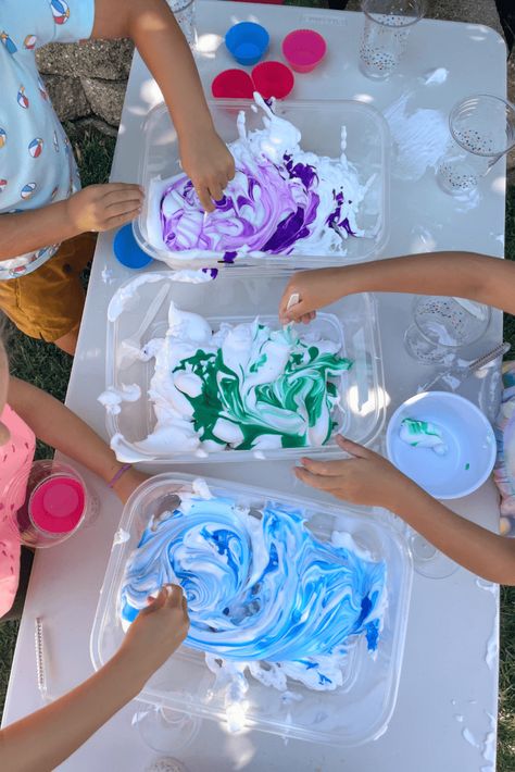 Children’s hands stirring blue and green liquid watercolors into white shaving cream, creating a swirling pattern during a sensory activity. Shaving Cream Play, Shaving Cream Sensory Play, Shaving Cream Activities, Shaving Cream And Food Coloring, Potions For Kids, Shaving Cream Art, Sensory Activities For Preschoolers, Water Table Activities, Green Liquid