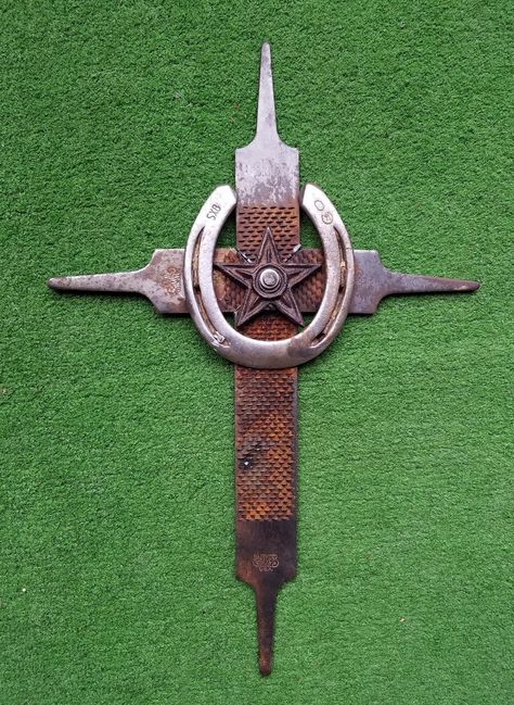 "Farrier Rasp/File Cross. Created from four upcycled rasps. Features a used horseshoe at the centre, surrounding a 3\" cast iron star. Rasps have varying degrees of rust with a very nice natural patina.  This cross fits any decor, home or barn, indoors or out. Also would make a fitting grave marker for your beloved companion.  Over all size 18\" x 12\".  Hanging loop on backside. Includes wall hanging hardware. Custom orders of any kind are always welcomed. See some of my other artworks at my we Cowboy Cross, Horseshoe Crafts Projects, Cool Welding Projects, Horseshoe Projects, Recycled Metal Art, Horseshoe Decor, Horseshoe Crafts, Cross Crafts, Welding Art Projects