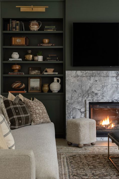 Shadow Avenue Living Room Revival | Ayesha Usman Design Closed Storage Living Room, Terrace Living Room Ideas, Moody Tv Room, Fireplace With Bookshelves On Each Side, Built In Shelves Living Room Fireplace, Fireplace With Bookshelves, Painted Built Ins, Marble Living Room, House Basement