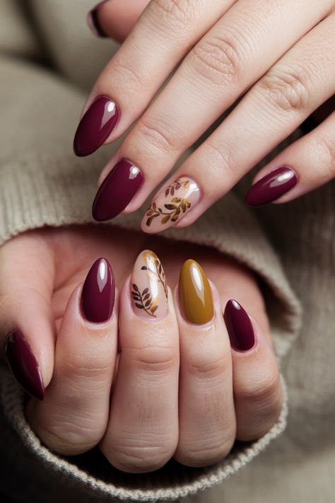 Embrace the beauty of the season with these stunning gel nails that perfectly capture fall nail ideas! Imagine a warm, deep burgundy base, accented with golden leaf designs that shimmer like autumn sunlight. This chic look not only complements the season's tones but also offers a lasting finish thanks to gel polish. Elevate your fall aesthetic and make a statement with these elegant nails! Nail Burgundy Designs, Burgundy Gel Nails Design, Autumn Leaf Nails, Finger Biting, Birmingham City University, Creative Nail Art, Fall Nail Ideas, Latest Nail Designs, Golden Nails