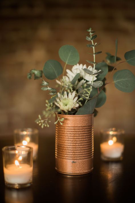 “Keeping in line with our budget, we had friends and family collect soup cans,” Charlee-Ann says. Although it was an unusual request from a bride, Charlee-Ann had a plan to spray-paint the cans an elegant copper color and use them as vases for the reception table centerpieces. Industrial Wedding Centerpieces, Gold Spray Paint Diy, Painted Tin Cans, Wedding Lantern, Wedding Burlap, Lantern Centerpiece, Rustic Wedding Decorations, Deco Champetre, Winter Centerpieces