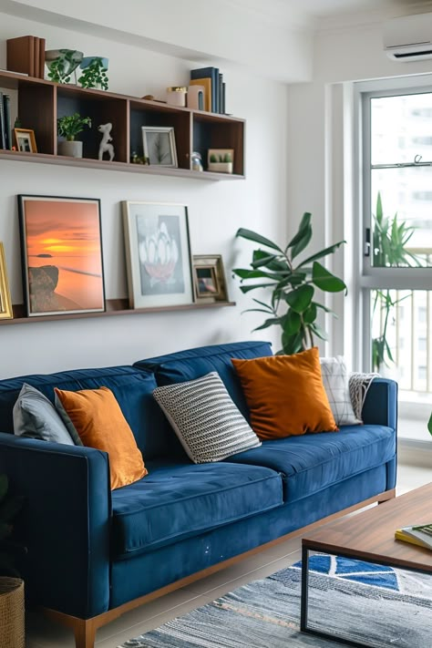 Blue Sofa Sitting Room Ideas, Blue Sofa Apartment, Navy Room Color Scheme, Two Color Sofa, Navy Blue Orange Living Room, Navy And Orange Living Room Decor, Cozy Living Room Art, Blue Sofa Mid Century Living Room, Living Room Inspiration Blue Sofa