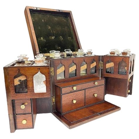 A 19th century English medicine chest by Clay and Abraham, Liverpool. A small antique mahogany medicine cabinet with brass handle dating from the early 19th century, which opens through the double doors to reveal an arrangement of bottles, with labels and contents, multiple drawers including weighing instruments and weights, mortar and pestle. A trade label on the bottles for Clay, Abraham Chemists, Liverpool. Their Shop on Bold Street The interior of the medicine chest has 14 compartments with Dream Home Library, Glass Bottle With Stopper, Vintage Home Office, Medicine Chest, Antique Glass Bottles, Apothecary Cabinet, Medicine Boxes, Vintage Medical, Brass Handle