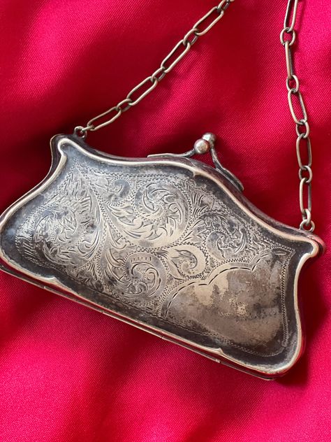 Here we have an Edwardian silver purse in a pretty good condition, fairly spacious inside( room for some small make up and credit card ). Inside lining is blue fabric, There are some stains on it, some signs of repairs. it locks properly, chain is long enough to hold in your hand or have it on your wrist. There are carved tapestry at the front, back in blank. There is a big dip in the back that may have happened many years ago. Item is for sale as is.  Measurements  4 to 3  2.5  Shipping outside USA and Canada has additional fee Vintage Handbags 1920s, Edwardian Handbags, Victorian Bag, Vintage Trinkets, Wrist Purse, Antique Objects, Silver Purse, Antique Christmas Ornaments, Beaded Cardigan