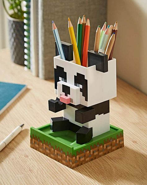 Add a touch of pixelated style to your home with this Panda Desktop Tidy. The 15cm (5.9) tall desktop organiser is shaped like the Panda from Minecraft. With an integrated stationery pot, trinket tray and universal phone stand, the possibilities for using your Panda are endless. The Panda Desktop Tidy will make a cute addition to your desk. Minecraft fans will love using it. Kids Desk Tidy, Desk Minecraft, Minecraft Panda, Minecraft Accessories, Minecraft Diy Crafts, Desktop Organiser, Minecraft Toys, Diy Minecraft, Retro Gaming Art