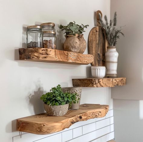 These floating shelves are not only practical but also add a minimalist, rustic charm to any space. With invisible mounting hardware, they seem to “float” on the wall, creating a clean, seamless look. Perfect for displaying plants, books, or decor, they’re a stylish way to make the most of vertical space. Floating Shelves Accent Wall, Floating Shelves Over Bar, Kitchen With No Cabinets, Raw Wood Shelves, Floating Shelves In Kitchen, Design Floating Shelves, Living Room Floating Shelves, Green Decor Ideas, Floating Wooden Shelves