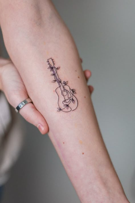 Mini Forearm Tattoo, Guitar Tattoo Forearm, Guitar Tattoo Design Ideas, Fineline Guitar Tattoo, Pretty Music Tattoos, Music Tattoo For Women, Line Art Guitar Tattoo, Guitar And Music Tattoo, Ukulele Tattoo Ideas