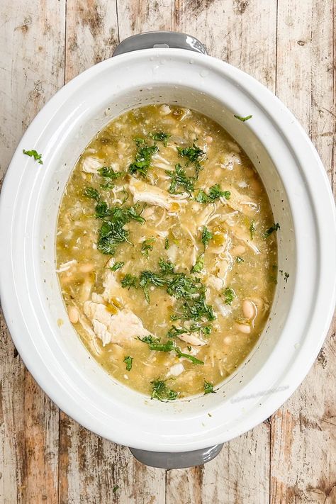 Break out the slow cooker for this easy Salsa Verde Soup recipe with chicken! This Crock Pot chicken soup couldn’t be easier to make. Layer chicken, onions, garlic, seasonings, white beans, and and a jar of flavorful salsa verde in your slow cooker, turn it on, and go about your day. Later on, you’ll come home to delicious Salsa Verde Chicken Soup, simmering and ready to top with sour cream, cheese, and tortilla chips. Yum! Chicken Verde Soup Crock Pot, Chicken Verde Soup, Salsa Verde Soup, Tortilla Soup Recipe Crockpot, Salsa Verde Chicken Soup, Crock Pot Chicken Soup, Soup Recipe With Chicken, Easy Salsa Verde, Verde Soup