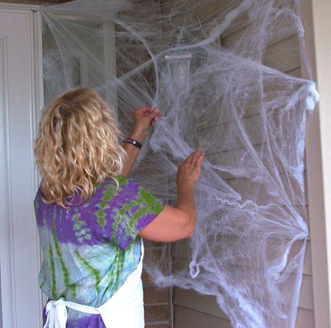 Cotton Spider Web Decoration, How To Put Up Spider Webbing, Window Spider Web Diy, Spider Webbing For Halloween, Decorating With Spider Webs, How To Hang Spider Webs For Halloween, Spider Web Door Decoration, Front Porch Spider Web Decor, Spider Web Front Door