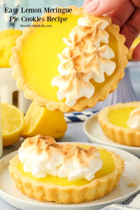 A lemon meringue pie cookie sits on a white plate, there is another cookie being held front forward above it Easy Lemon Meringue Pie, Lemon Curd Cookies Recipe, Easy Lemon Meringue, Pie Cookies Recipe, Lemon Meringue Tarts, Mini Lemon Meringue Pies, Lemon Chiffon Pie, Lemon Meringue Pie Easy, Lemon Meringue Cookies