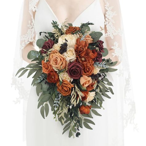 PRICES MAY VARY. Unique Cascading Beauty: Make a statement with this exceptional cascading burnt orange bridal bouquet. Its cascading design adds a touch of drama and elegance to your wedding ensemble. Realistic Silk Flowers: Expertly crafted with the finest artificial silk flowers, this bouquet mimics the natural world so convincingly that your guests will think they're real. Radiant Terracotta Hues: The terracotta color scheme is the epitome of autumn charm. It radiates warmth, making it the p Fall Colored Flowers Wedding, White Rose Fall Bouquet, Country Rustic Wedding Flowers Bridal Bouquets, Wedding Decor For Fall Weddings, Country Wedding Burnt Orange, White Roses Fall Wedding, Fake Flower Wedding Bouquet, Terracotta And Sage Boutonniere, Rust Orange Bridal Bouquet