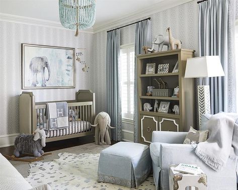 Sophisticate nursery design features elephant art mounted on white and silver animal print wallpaper over a gray French crib with a gray Hermes throw blanket, a safari animal mobile, large stuffed felt elephant, a light gray accent chair with ottoman, a white and gray floor lamp, and a gray bookshelf. Hermes Blanket, Kids Interior Design, Expensive Furniture, Luxury Furniture Brands, Top Furniture, Elephant Nursery, Best Interior Design, Ashley Furniture, Home Decor Trends