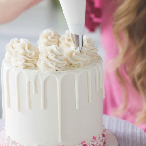 So This Is How You Decorate a Cake Like a Pro | Brit + Co Perfect Drip Cake, Candy Melt Drip Cake, Rosette Drip Cake, Icing Swirls On Cake, How To Make Swirls On Cake, Drip Icing Recipes Easy, Candy Melt Drip Recipe, How To Make A Drip Cake Step By Step, Cake Dripping Icing How To Make