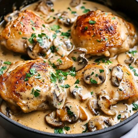 Chicken Thighs With Creamy Mushroom Garlic Sauce Recipe - sandyrecipes.com Creamy Mushroom Chicken Thighs, Fish And Mushroom Recipe, Creamy Garlic Herb Cajun Chicken Thighs, Chicken Thigh And Pasta Recipes, Chicken Thigh Recipes Dutch Oven, Mushroom Chicken Recipes, Creamy Garlic Mushroom Chicken, Mushroom Chicken Thighs, Chicken With Mushroom Sauce