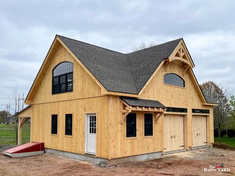 Recently built by our crew in South Windsor, CT: 28' x 36' Newport Garage featuring an 18' reverse gable dormer with Anderson bow top window, a 28' shed dormer, timber frame accents, and an 8' x 36' open timber frame lean to. Ready to get started with your new custom garage? Get in touch with the experts directly by contacting us via our website. Dormer Window Above Garage, Large Gable Dormer, Garage With Shed Dormer, Gabled Dormer, Tudor Garage Addition, Timber Framed Garage, Barn Style Garage, Garage Builders, Gambrel Style