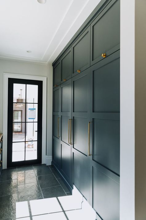 Built in floor-to-ceiling storage space with dark blue green cabinetry and gold cabinet pulls. | shorelineconstructionsc.com Hallway Storage Cabinet, Cabinets To Ceiling, Floor To Ceiling Cabinets, Gold Cabinet Pulls, Mudroom Cabinets, Mudroom Flooring, Ceiling Shelves, Wall Storage Cabinets, Mud Room Entry