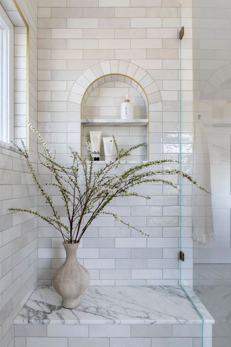 Designed by C.LehmanHome, the details of this serene, transitional primary bedroom are stunning. The arch niche in the stunning white shower is unique - a beautiful bathroom design moment. #showerdesign #whiteshower #whitetileshower #bathroominspiration #luxurybathroom Shower White Tile, Niche In Shower, Shower Niche Ideas, Shower Luxury, White Tile Shower, Bathroom Niche, Marble Tile Bathroom, Shower And Bath, Master Shower