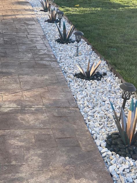 Grass Rock Border, Inground Pool Landscaping Ideas Rock Waterfall, White Rock Border Landscaping, River Rock Around Patio, Sidewalk With Rocks, Backyard With Rocks Ideas, Driveway Lined With Rocks, Rock Bed Plants, Driveway Lined With Plants