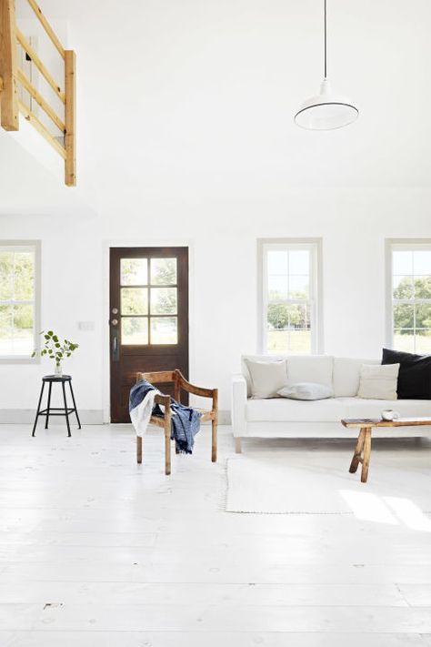 The white walls, floors, molding, and furniture in this small Indiana home look stunning when paired with rich and rustic wood accents. Modern Americana, White Living Room Decor, Living Room Wood Floor, White Couch, White Wood Floors, Room White, Design Salon, Room Color, White Living