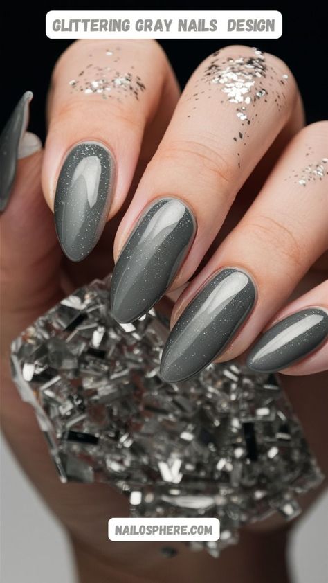 Embrace the elegance of the night sky with this sophisticated smoky gray nail design, adorned with delicate specks of glitter that evoke the shimmering stars. The sleek, elongated shape of the nails enhances the overall refined look, while the subtle sparkle adds a touch of cosmic magic. Perfect for those who appreciate a blend of understated luxury and celestial beauty, this manicure is ideal for both formal events and everyday glamour. Spice Nails, Cosmic Magic, Olive Nails, Gray Nail, Grey Nail Designs, Gray Nails, Understated Luxury, Nail Designs Glitter, Nail Art Galleries