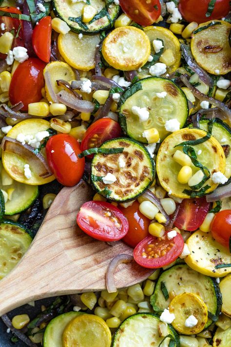 This vibrant Sautéed Summer Vegetable medley features seasonal farmers' market favorites: zucchini and summer squash, sunshine-y corn, savory red onion, and sweet-tart tomatoes ... all highlighted by a cascade of fresh basil and crumbles of creamy goat cheese. Such a simple summer side dish recipe, yet it’s surprisingly, addictively delicious! A definite upgrade from plain, sauteed zucchini recipes! | Ready in Under 30 | Make-Ahead Steps | Vegetarian | Gluten Free | www.TwoHealthyKitchens.com Sauteed Zucchini Recipes, Recipe With Basil, Zucchini And Summer Squash, Summer Vegetable Recipes, Summer Side Dishes Recipes, Summer Squash Recipes, Goat Cheese Crostini, Creamy Goat Cheese, Zucchini Tomato