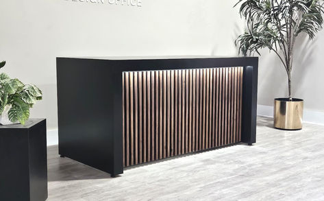 Transform your office or retail space with the stunning Aventurine Reception Desk from MARAM DESIGN OFFICE. This desk is crafted with the highest quality plywood and MDF, and features a beautiful poplar or maple wood design that adds a touch of elegance to any space. The scratch and heat-resistant laminate finish ensures that your desk stays in pristine condition for years to come. With 20 different color and combination options available, you can customize your desk to match your unique style. Wood Slat Reception Desk, Front Desk Ideas, Wooden Reception Desk, Consulting Room, Black Drawers, Whiskey Bar, Maple Walnut, Reception Area, Dark Interiors