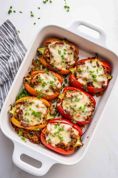 Overhead shot of a baking tray filled with vibrant bell peppers stuffed with savory ground beef and melted mozzarella cheese, fresh out of the oven. Cheesesteak Stuffed Bell Peppers, Cheese Steak Stuffed Peppers, Steak Stuffed Peppers, Cheap Healthy Dinners, Easy Keto Meal Plan, Roasted Pork Tenderloins, Cheese Steak, Beef Casserole Recipes, Dinner With Ground Beef