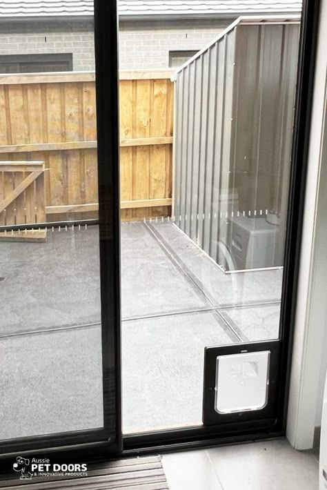 A Medium sized Black APD Rectangular Doggy Door installed into a glass sliding door by Aussie Pet Doors. 
Call us on 1300 558 577 or get a free installation quote via our website. Sliding Door With Dog Door, Dog Door In Glass Door, Pet Door Sliding Glass Door, Sliding Door Dog Door, Sliding Glass Dog Door, Single Patio Door, Aluminium Glass Door, Doggy Door, Dog Doors