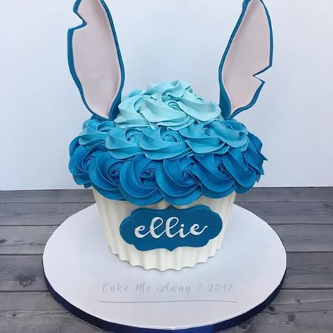 Ellie's Stitch inspired giant cupcake smash cake! Love the ears! 💙 cakemeaway #cakemeawayfresno #stitchcake #ohana #moanaandstitch #hawaiiantheme #1stbirthdaycake #1stbirthday #1stbirthdayparty #giantcupcakecake #smashcake #customcakes #buttercream #buttercreamrosettes #cakedecorating #cakeart #cakestyle #cakedecorator #instacake #cakesofinstagram #instacupcakes #cupcakesofinstagram #instasweet #bakedwithlove #ohanameansfamily Stitch Smash Cake 1st Birthdays, Stitch Smash Cake, Giant Cupcake Smash Cake, Cupcake Smash Cake, Cupcake Smash Cakes, Lilo And Stitch Cake, Giant Cupcake Cakes, Stitch Party, Stitch Cake