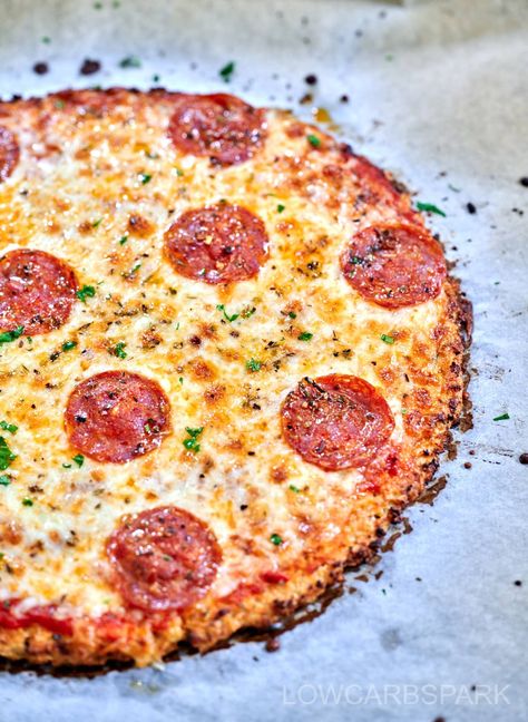 This cauliflower pizza crust recipe is the perfect solution for a low-carb, gluten-free, and grain-free pizza night. Made with fresh or frozen cauliflower, herbs, and cheese, it results in a crispy crust that can hold any slice. Easy to prepare and deliciously tasty, this crust is perfect for topping with your favorite goodies and will leave everyone asking for more. Wheat Free Pizza Crust, Colliflower Pizza Crust, Cauliflower Crust Pizza Recipes, Frozen Cauliflower Pizza Crust, Cauliflower Flatbread Recipes, Cauliflower Crust Recipes, Coliflower Pizza, Rice Pizza Crust, Cauliflower Rice Pizza Crust