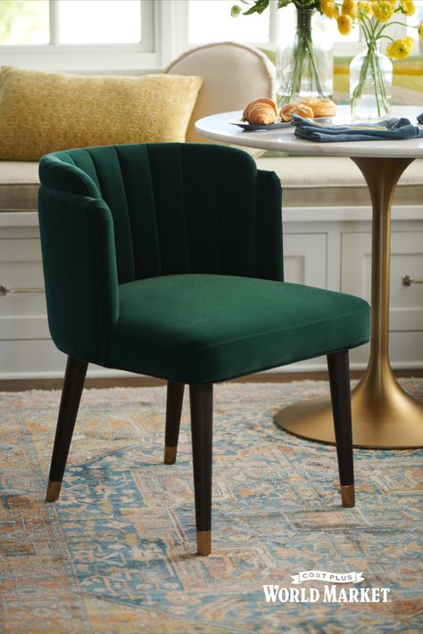 Upholstered in dark emerald green velvet with a curved channel-back, our exclusive Isadora dining chair blends glamorous Art Deco design with lasting comfort. Its sculptural silhouette is both sumptuous and suitably plush for long dinner sessions, with a wide fixed seat and subtly sheltering sides. Tapered legs in a dark brown, nearly black hue feature gold metal tips for that finishing touch of luxe. #worldmarket #chair Emerald Dining Chairs, Cool Dining Chairs, Emerald Green Dining Chairs, Green Velvet Dining Chairs, Black Velvet Dining Chairs, Art Deco Dining Chairs, Tea Room Design, Tea Room Decor, Art Deco Dining Chair