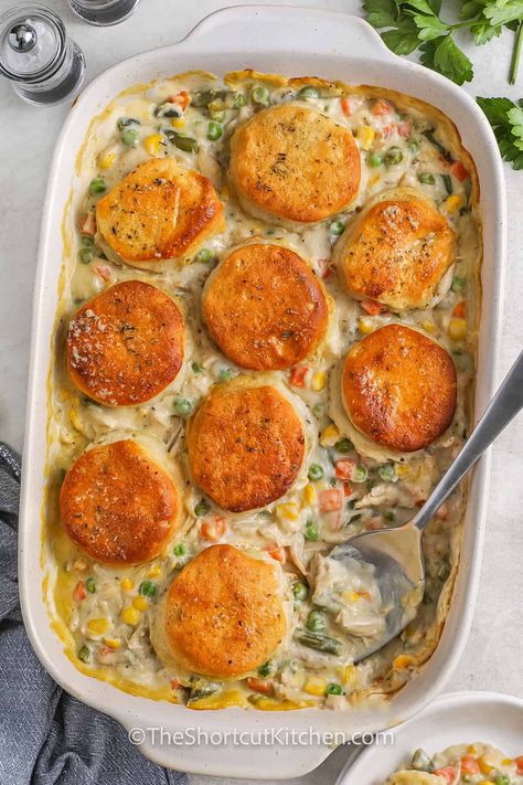 When you're craving comfort food but need something quick, this easy chicken pot pie recipe is the answer. It’s packed with shredded chicken, mixed veggies, and a creamy sauce, all baked under a layer of buttery biscuits. The garlic butter brushed on top adds extra flavor, making it the perfect cozy dish for any night of the week! #theshortcutkitchen Best Chicken Pot Pie Recipe With Biscuits, Pot Pie Chicken Casserole, Chicken Pot Pie Biscuits Easy, Chicken Pot Pie Biscuit Recipe, Chicken Pot Pie Topped With Biscuits, Crescent Roll Chicken Pot Pie Casserole, Chicken Pot Pie With Biscuits And Frozen Veggies, Pot Pie Bake With Biscuits, Chicken Pot Pie Recipe Biscuits