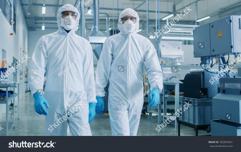 Two Engineers/ Scientists in Hazmat Sterile Suits Walking Through Technologically Advanced Factory/ Laboratory. Clean High-Tech Environment with CNC Machinery. Royalty Free image photo Microbiology Lab, Semiconductor Manufacturing, Air Filtration System, Pharmaceutical Industry, Now Is The Time, Clean Room, High End Fashion, Scientists, Tesla