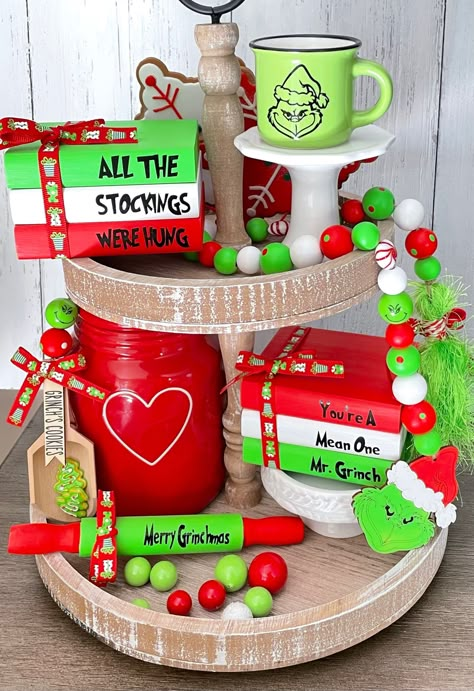 "Grinch Tiered Tray Decor  These cute Grinch themed decor items are perfect for accenting your home for Christmas. As well as your Tiered Trays and Rae Dunn displays for the season! BOOK STACK IS APPROXIMATELY                         ‼️ 4\"x 3.5\"x 2.25\" ‼️ Choose one or more from the following: -Garland 28\" - Scoop Garland 6\" - Mug 3\" - Rolling Pin 7\" - Wood book stack is approximately        4\"x 3.5\"x 2.25\".  All of my products are handmade to order. Please know that slight variations Mini Grinch Tree Topper, Grinch Tiered Tray Decor Diy, Themed Tiered Tray Decor, S’mores Tiered Tray Decor, How To Make Tiered Tray Decor, Grinch Tray Decor, Grinch Book Stack, Christmas Tiered Tray Ideas Diy, Grinch Christmas Home Decor