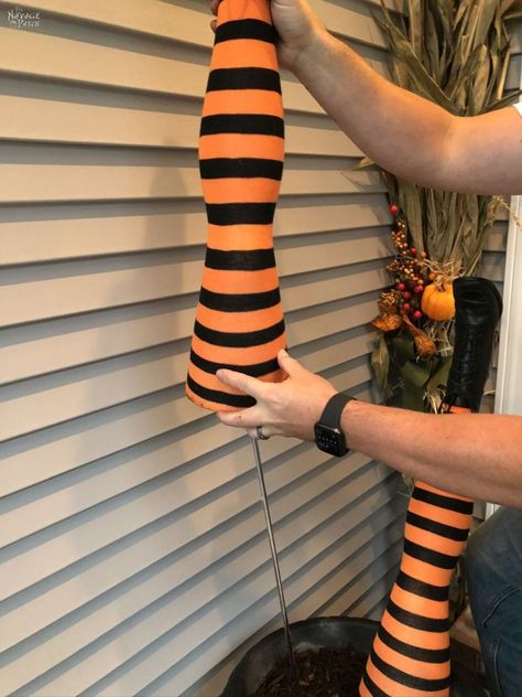 DIY Witch Legs (Grandin Road Inspired) | DIY Grandin Road Knockoff Witch Legs | DIY Witch Is In sign with Dollar Store supplies | DIY life-size Witch Legs | DIY life-size Halloween prop | #TheNavagePatch #Upcycled #easydiy #DIY #Halloweendecor #DollarStore #Knockoff #Halloween #grandinroad #Repurposed #DollarTree #witch | TheNavagePatch.com Witches Legs Decorations Diy, Witches Legs Decorations, Witch Legs Diy, Outdoor Witch Decor, Witch Decorations Diy, Grandin Road Halloween, Outdoor Witch, Halloween Witch Legs, Diy Halloween Witch