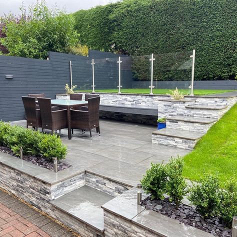 We love how this design has created 3 garden levels separating the upper lawn area with glass balustrade from a paved outdoor dining space.  #gardenideas #gardeninpiration #paving #balustrade #gardendesign #gardens #landscaping Tiered Garden Ideas, Tiered Gardens, Tiered Landscape, Garden Design Outdoor, Front Garden Ideas Driveway, Small Garden Plans, Garden Ideas Driveway, Garden Ideas Uk, Terraced Garden