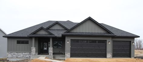 Residential Rambler Charcoal Siding Black Trim, Rambler Exterior Paint Colors, Grey And Black Exterior House Colors, Dark Grey House Exterior Black Trim, Dark Grey Siding With Black Trim, Gray House Black Windows, Black Gutters Gray House, Grey House Black Trim, Black Soffit And Fascia